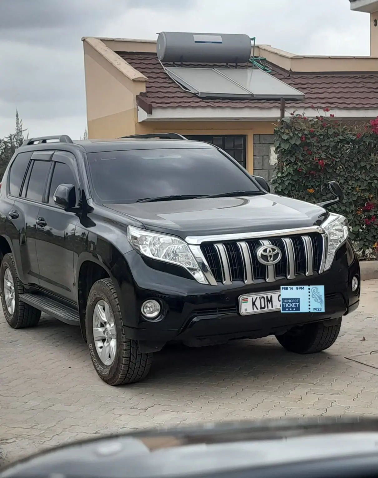 Black Toyota Land Cruiser Prado in an urban driveway