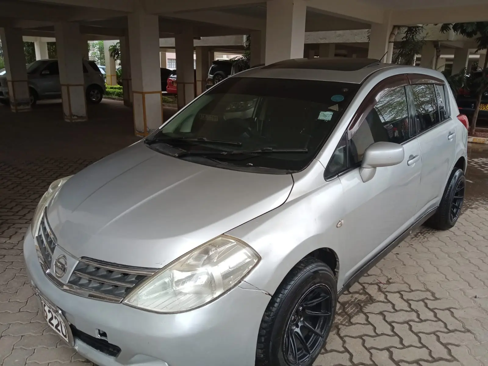 Silver Nissan Wingroad station wagon photographed from the front