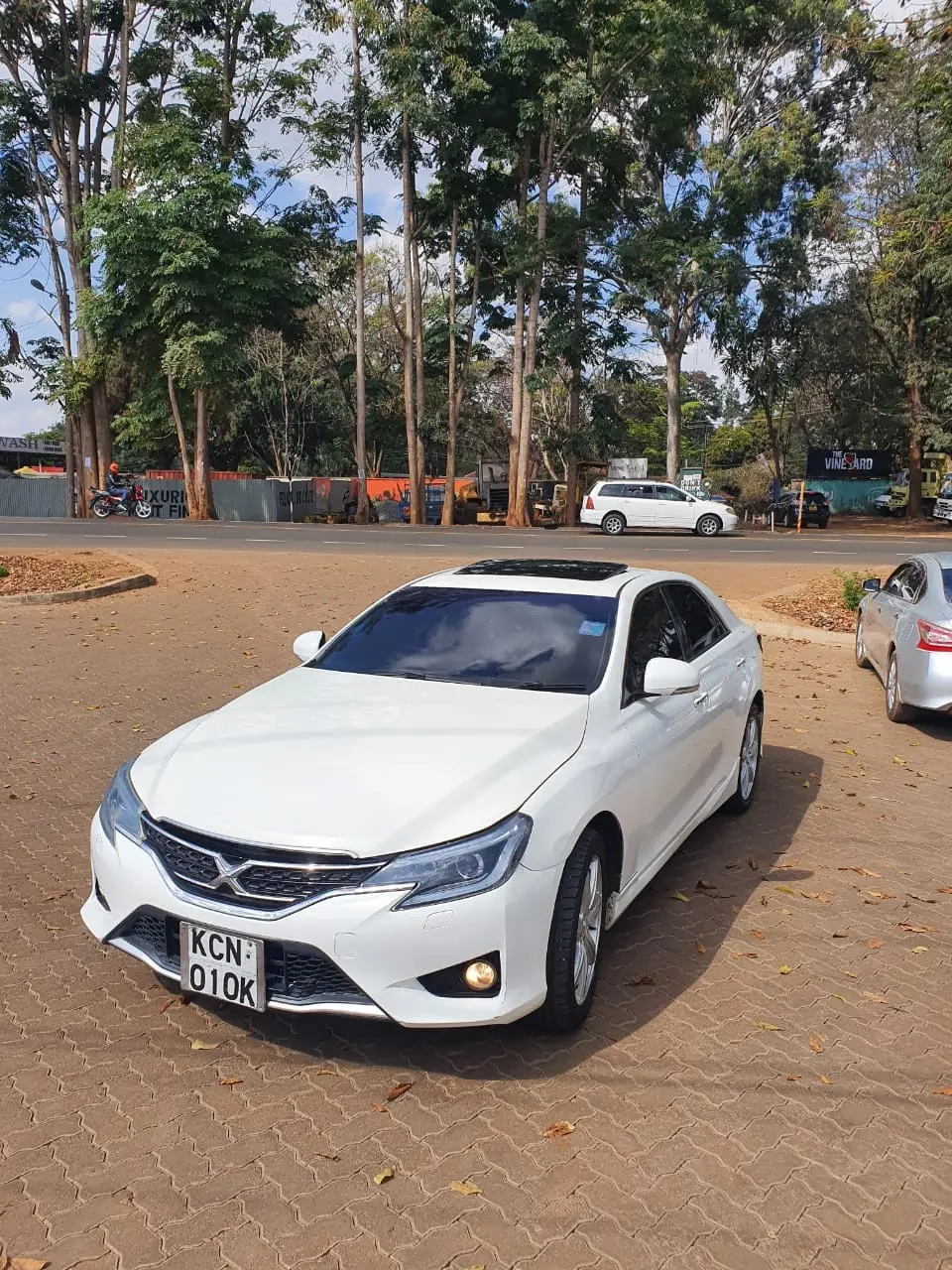 White Toyota Mark X executive saloon photographed from the front